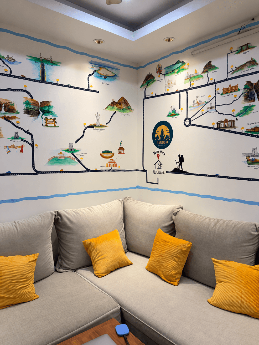 Lounge corner sofa under the hand-painted travel map mural